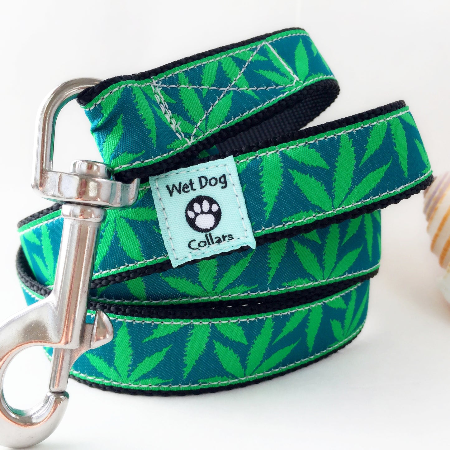 Green marijuana leaf-patterned dog leash with saltwater proof stainless swivel clip for beach use