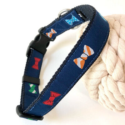 Navy blue dog collar with colorful bowties made for saltwater with stainless hardware